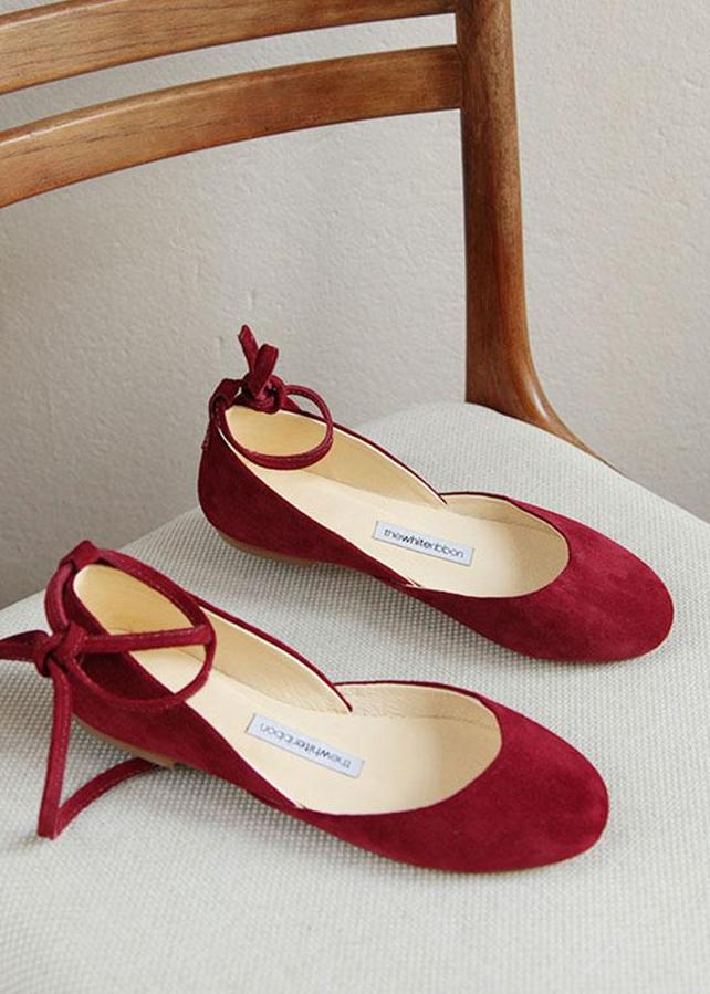 Cherry red suede ballet flats with long leather ankle ribbons in sideview