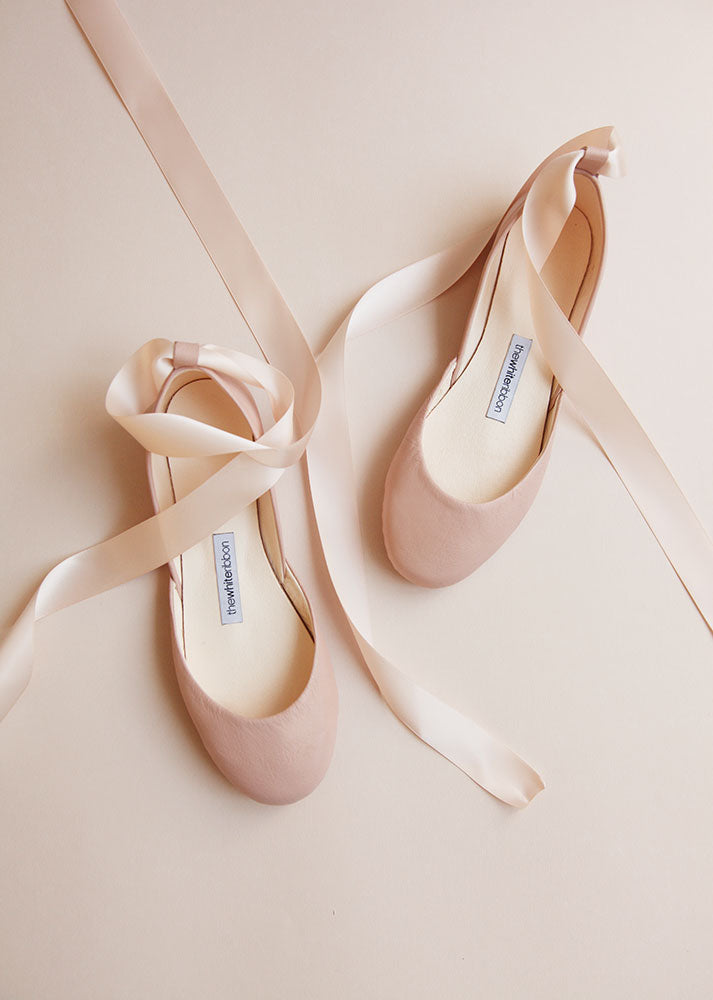 top shot of leather ballerinas in nude with satin straps