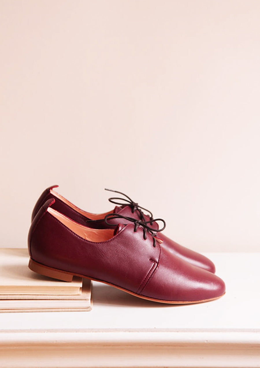Bordeaux derby shoes from sideview on top of shelf