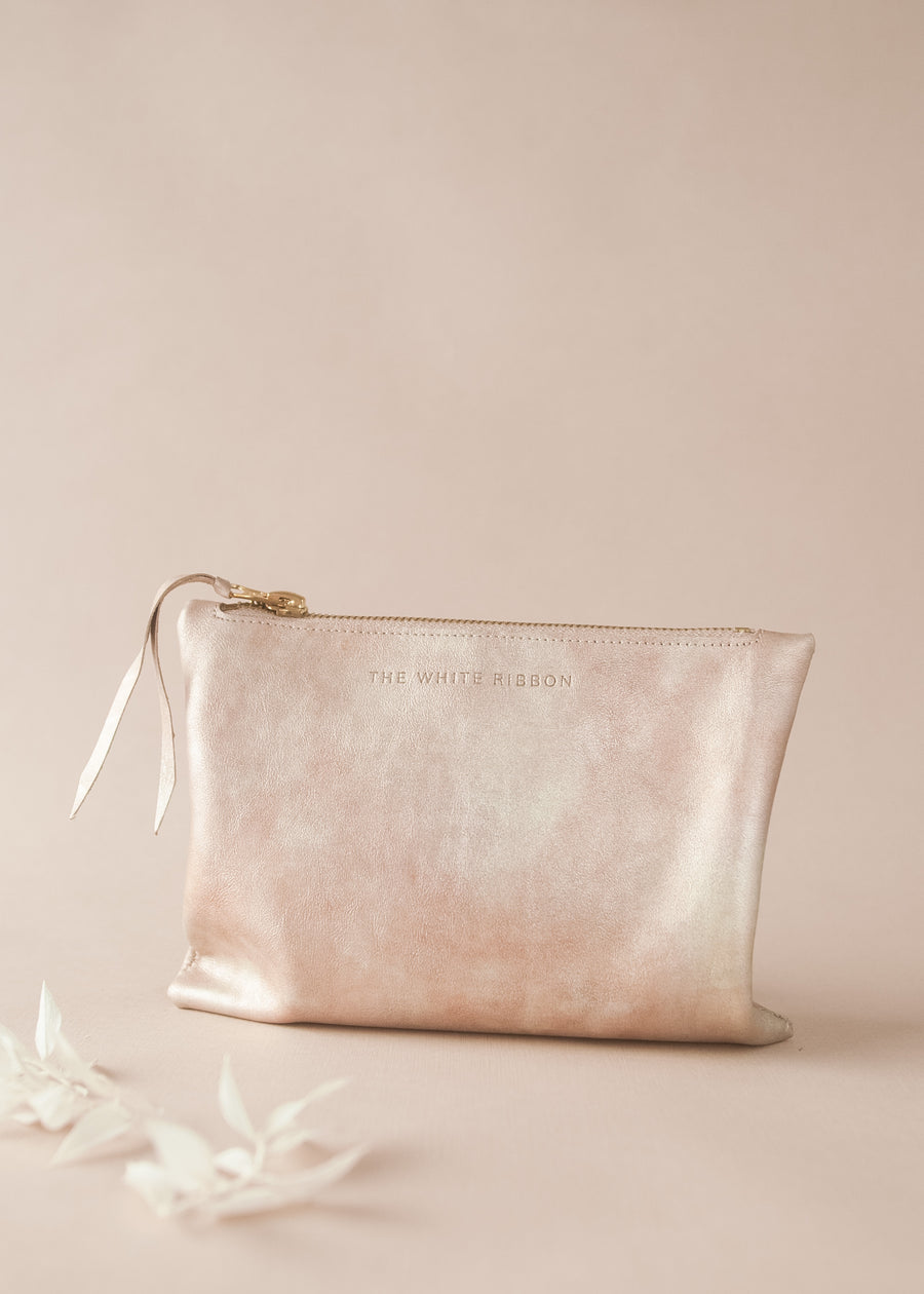 rose gold clutch on neutral background