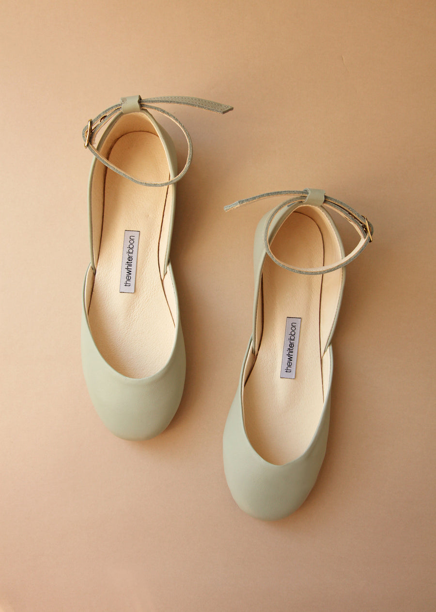 pastel mint coloured leather ballet flats with matching lether straps in top view