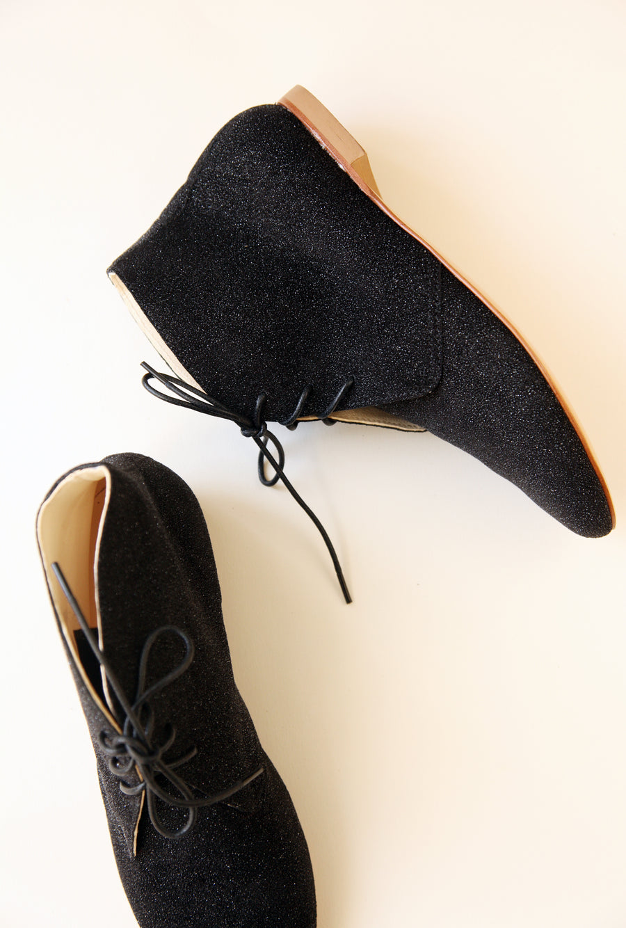 top and side view of a pair of ankle boots in sparkling black colour 