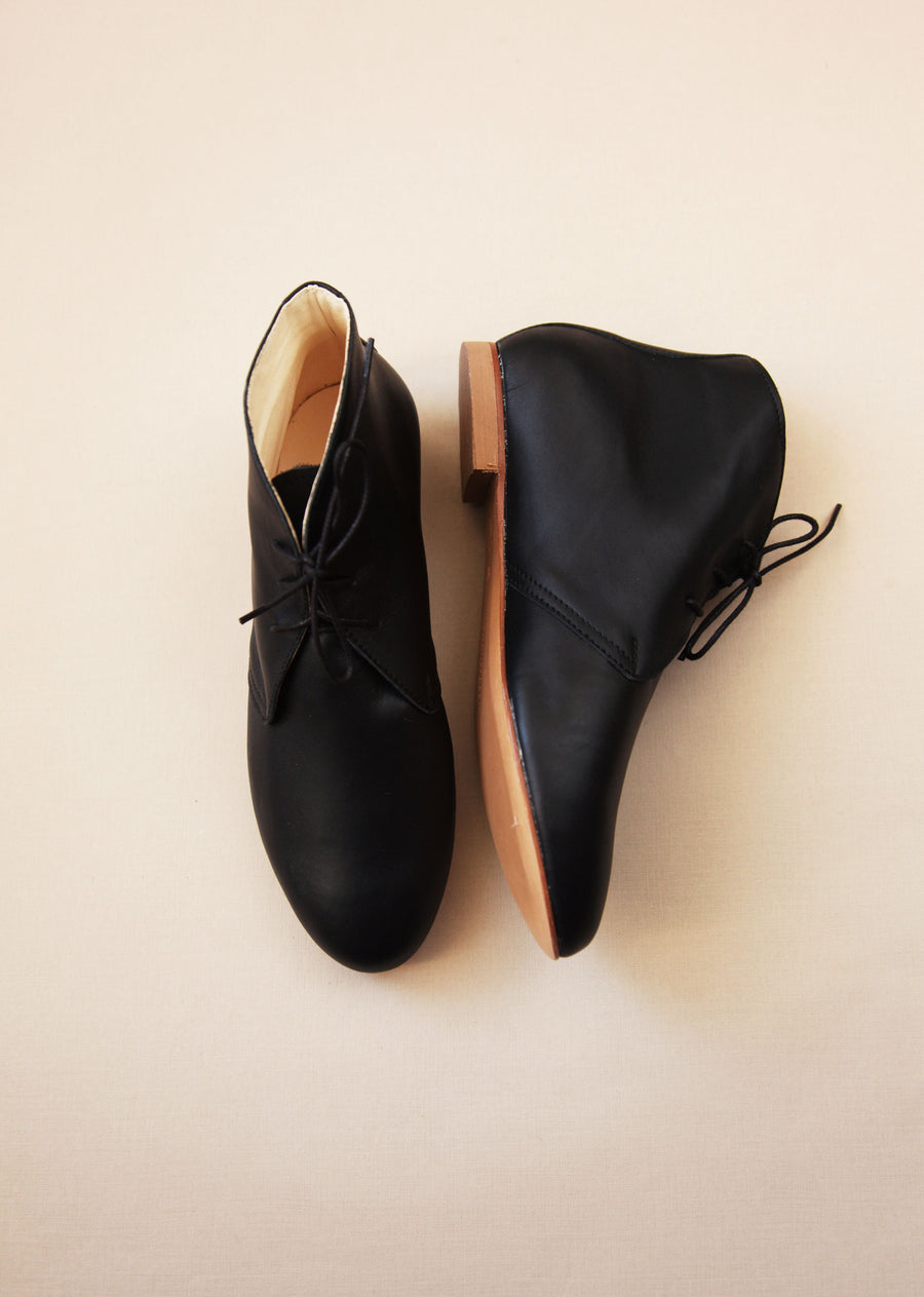 black smooth leather ankle boots shown from top and side 