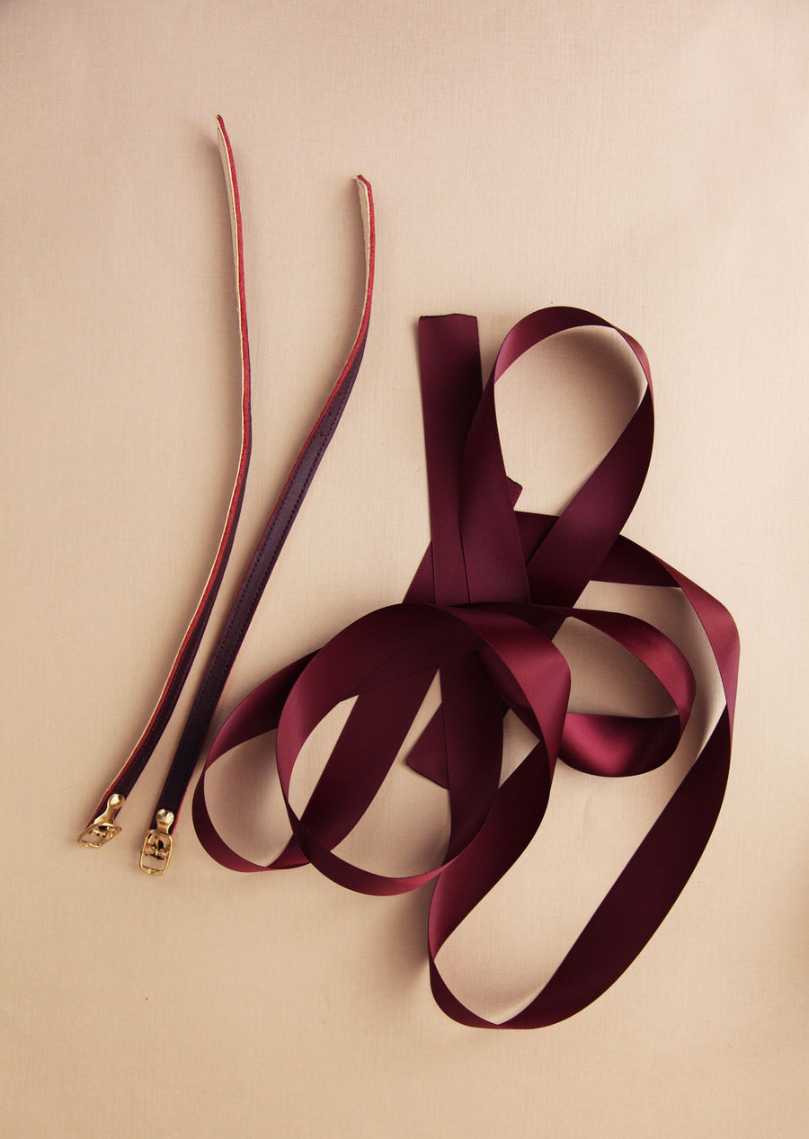 bordeaux satin and leather ankle straps on cream background