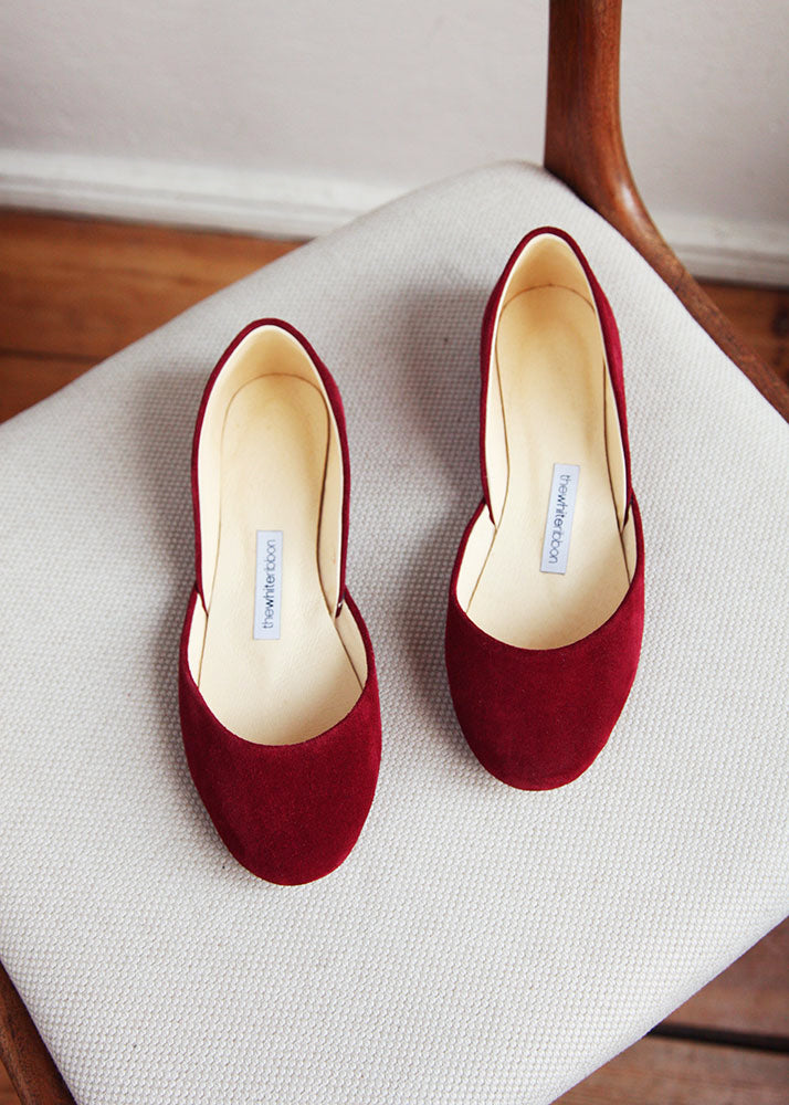 cherry red soft nubuk leather ballerinas from the top on light background