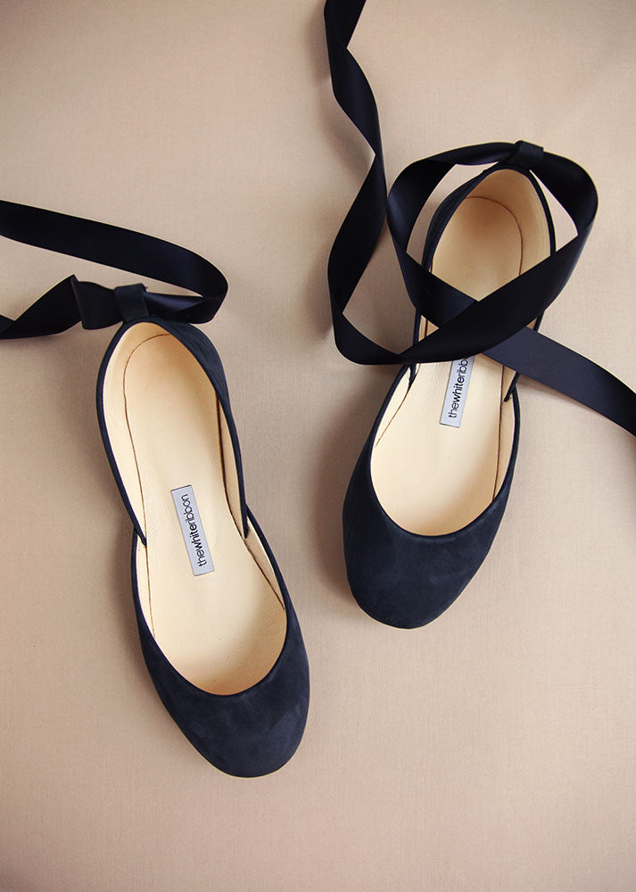 dark blue soft leather ballet flats with matching satin ribbons in top view